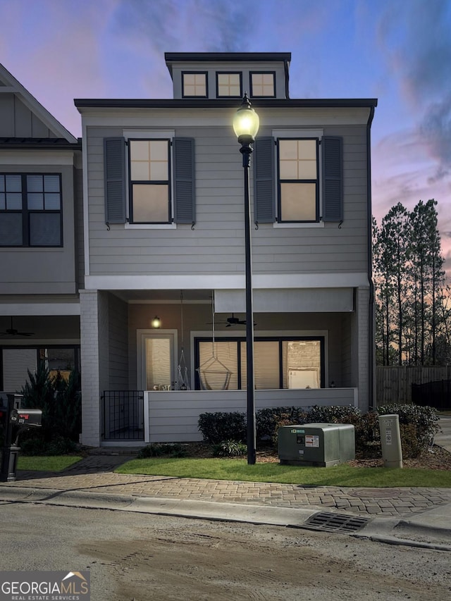 view of front facade with brick siding and fence