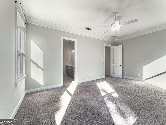 unfurnished bedroom with ornamental molding, carpet flooring, visible vents, and baseboards