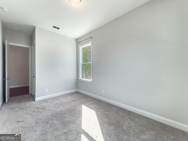 unfurnished bedroom featuring baseboards, visible vents, and carpet flooring