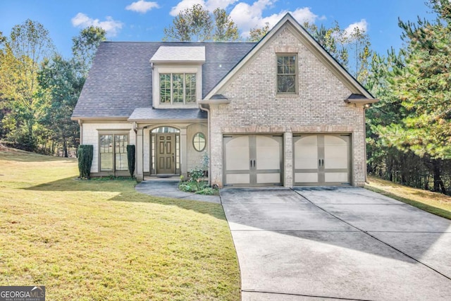 view of front of house featuring a front yard and a garage