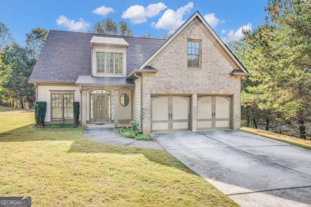 view of front of home with a front yard and a garage