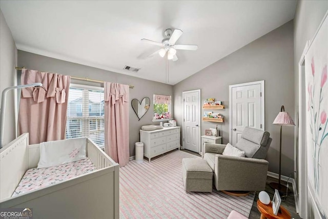 bedroom with light colored carpet, vaulted ceiling, and ceiling fan