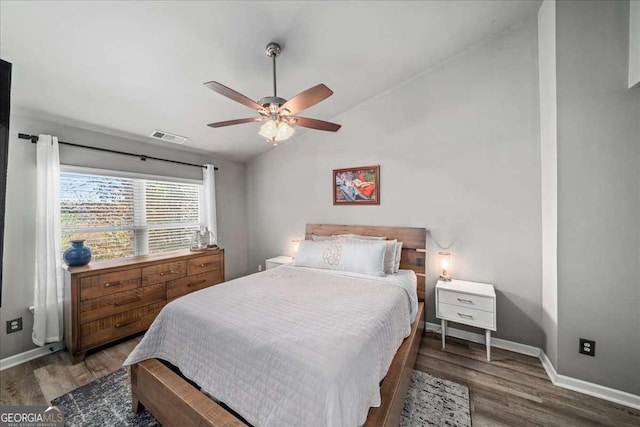 bedroom with ceiling fan, dark hardwood / wood-style floors, and lofted ceiling