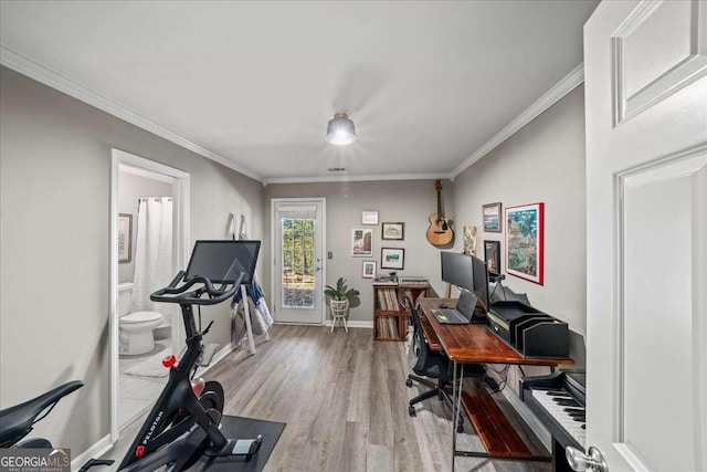 home office featuring crown molding and light hardwood / wood-style floors