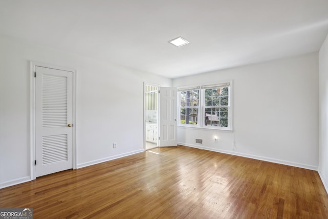 unfurnished room with light hardwood / wood-style floors