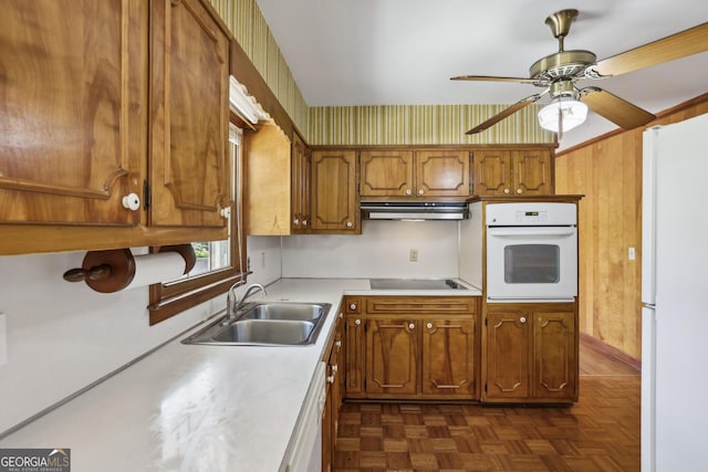 kitchen featuring ceiling fan, sink, dark parquet floors, and white appliances