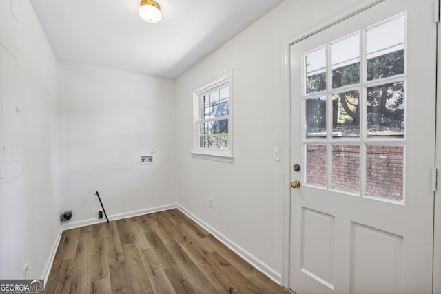 laundry room featuring plenty of natural light, dark wood-type flooring, and washer hookup