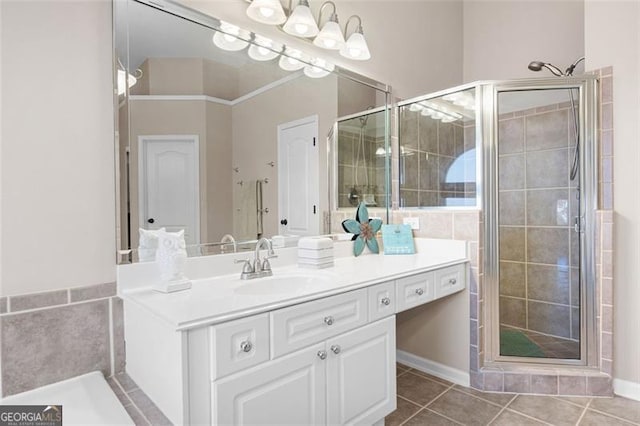 bathroom featuring tile patterned flooring, vanity, and walk in shower