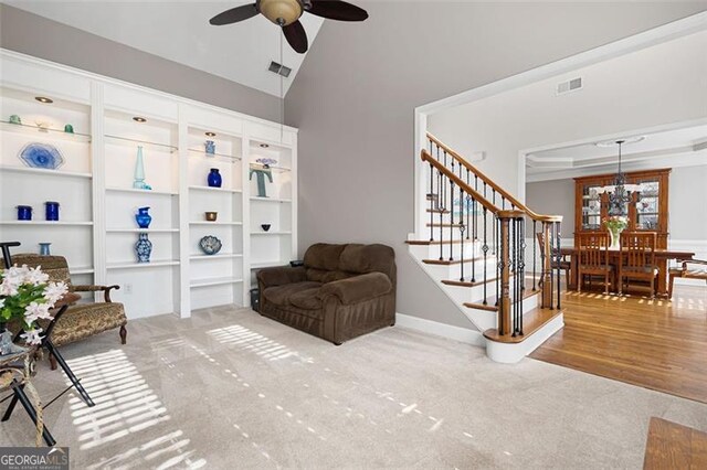 sitting room with ceiling fan, hardwood / wood-style floors, and lofted ceiling