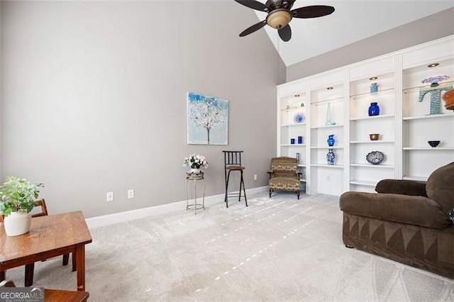 sitting room featuring ceiling fan, light colored carpet, and high vaulted ceiling