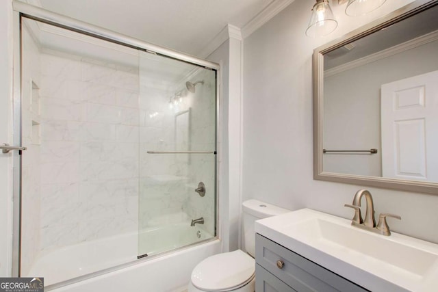 full bathroom featuring shower / bath combination with glass door, vanity, toilet, and ornamental molding