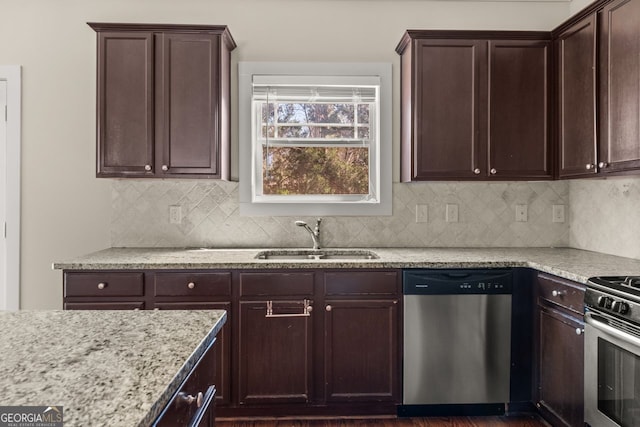 kitchen with a sink, tasteful backsplash, stainless steel appliances, light stone countertops, and dark brown cabinets