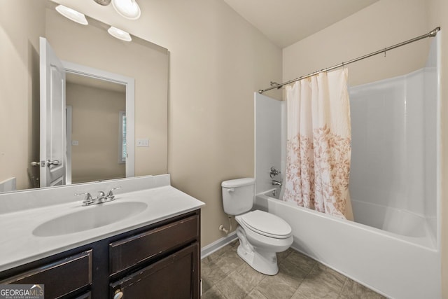 full bath with toilet, vanity, baseboards, and shower / bath combo