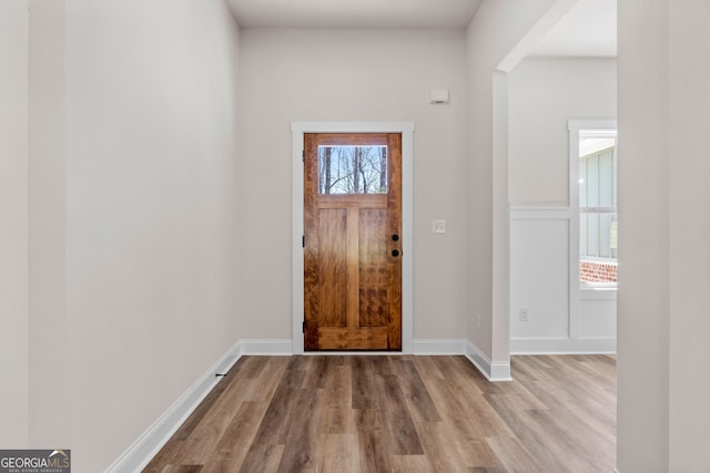 entryway featuring light wood finished floors and baseboards