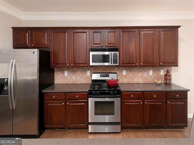 kitchen with stainless steel appliances, tasteful backsplash, and ornamental molding