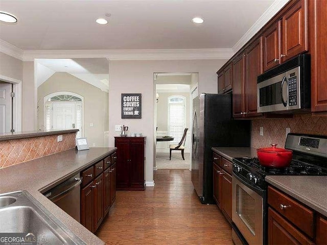 kitchen featuring decorative backsplash, ornamental molding, dark hardwood / wood-style floors, and appliances with stainless steel finishes