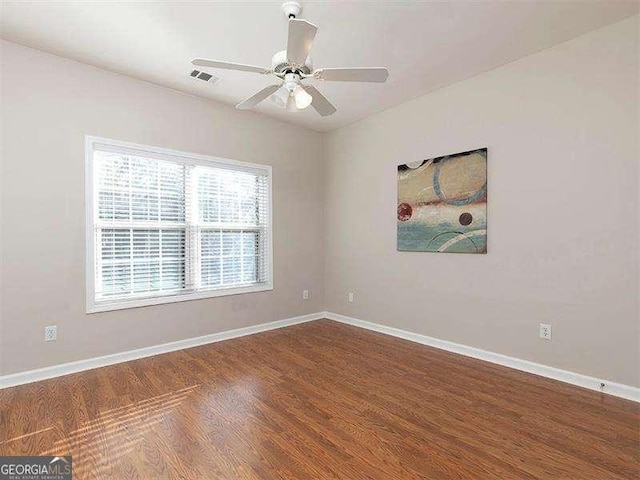 empty room featuring ceiling fan and hardwood / wood-style flooring