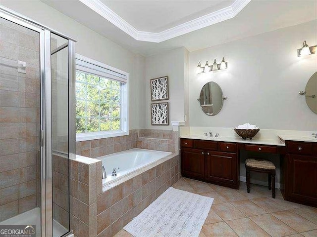 bathroom featuring tile patterned floors, ornamental molding, vanity, a tray ceiling, and shower with separate bathtub