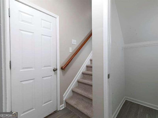 stairs featuring hardwood / wood-style floors