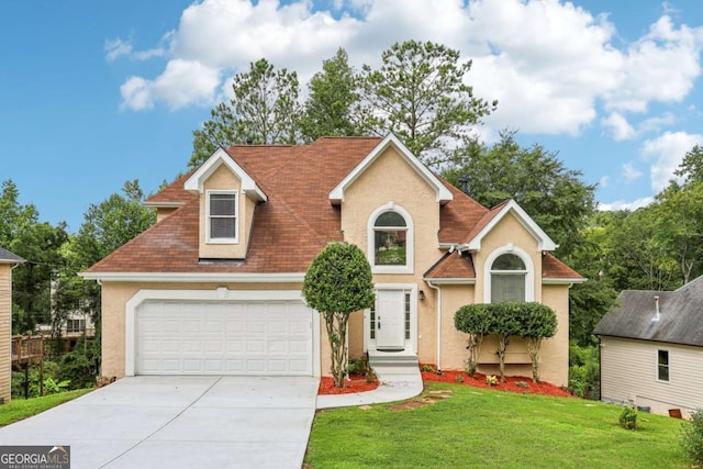 view of front of property with a front yard and a garage