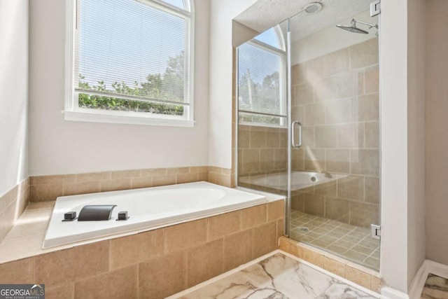 bathroom featuring shower with separate bathtub and a wealth of natural light