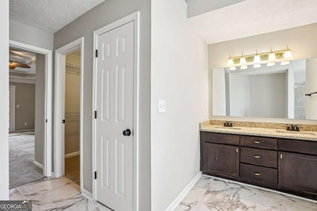 bathroom with vanity and a textured ceiling