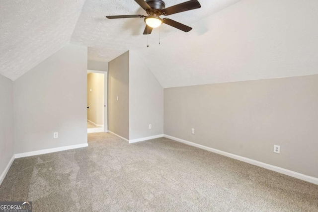 bonus room with ceiling fan, carpet floors, a textured ceiling, and lofted ceiling