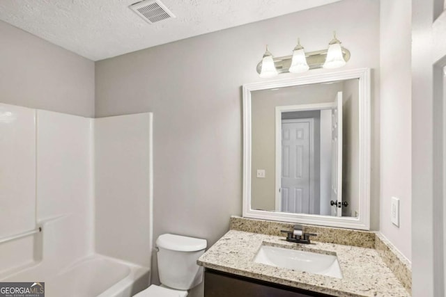 full bathroom featuring shower / tub combination, vanity, a textured ceiling, and toilet