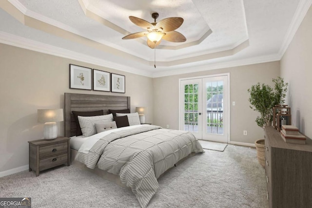 carpeted bedroom with a raised ceiling, access to exterior, ceiling fan, and crown molding