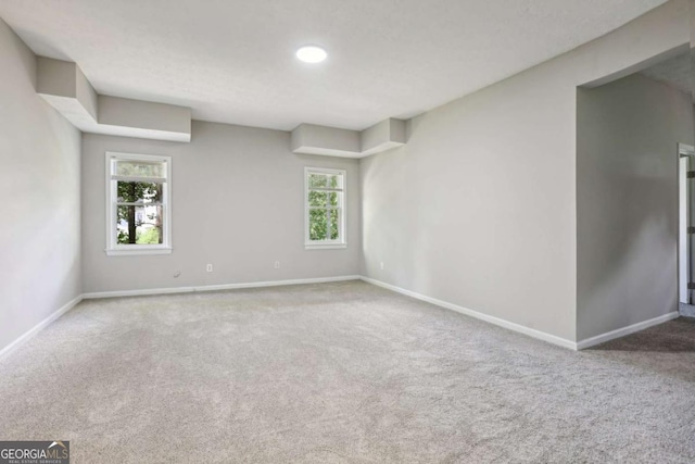 empty room with carpet flooring and plenty of natural light