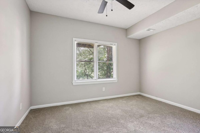 carpeted spare room with ceiling fan