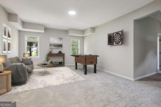 game room with plenty of natural light and light colored carpet