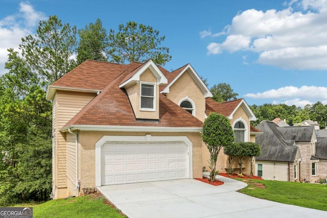 view of front facade with a front yard and a garage