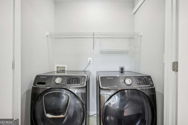 clothes washing area featuring independent washer and dryer