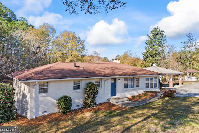 single story home with a carport and a front yard