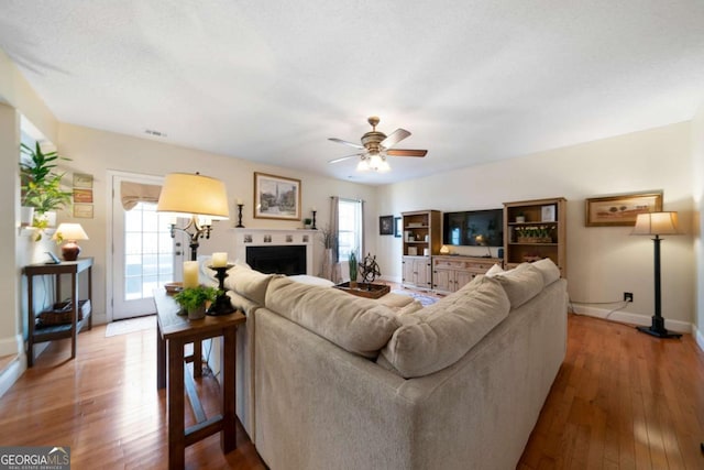 living room with hardwood / wood-style floors and ceiling fan