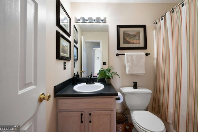 bathroom featuring vanity and toilet