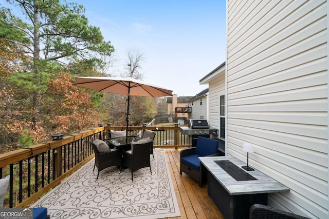 deck with a grill and an outdoor hangout area