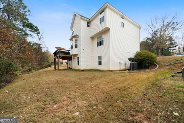 rear view of property with a yard and a deck