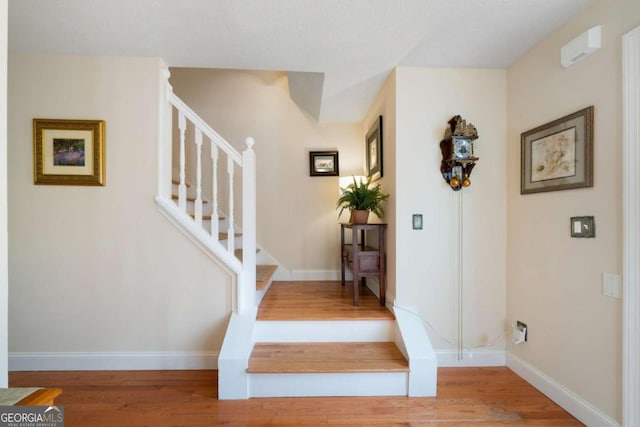 stairs featuring wood-type flooring