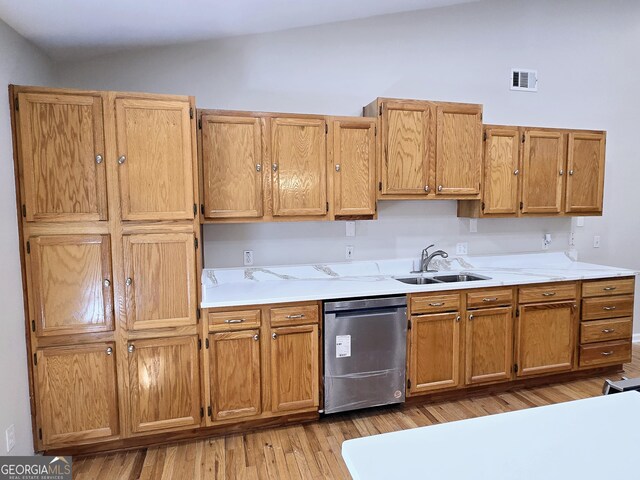 kitchen featuring stainless steel dishwasher, lofted ceiling, sink, and light wood-type flooring