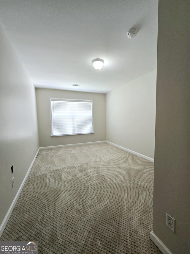 spare room featuring carpet