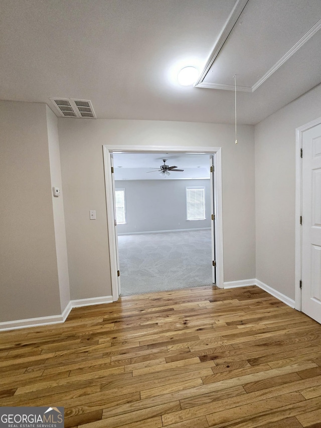 spare room featuring ceiling fan and light hardwood / wood-style flooring