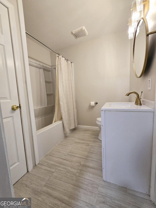 full bathroom with shower / bath combination with curtain, vanity, and toilet