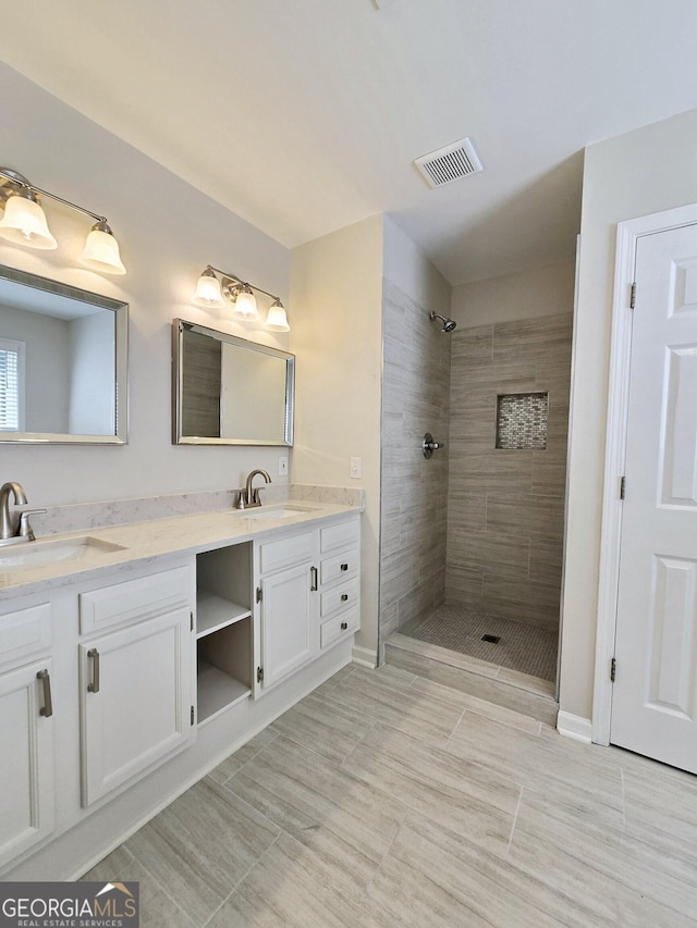 bathroom featuring vanity and a tile shower