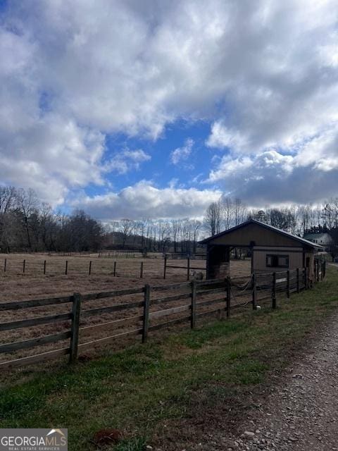 view of yard featuring an outbuilding and a rural view