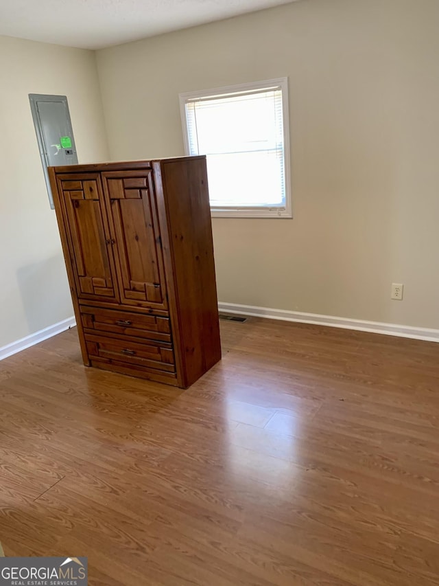 unfurnished bedroom with wood-type flooring