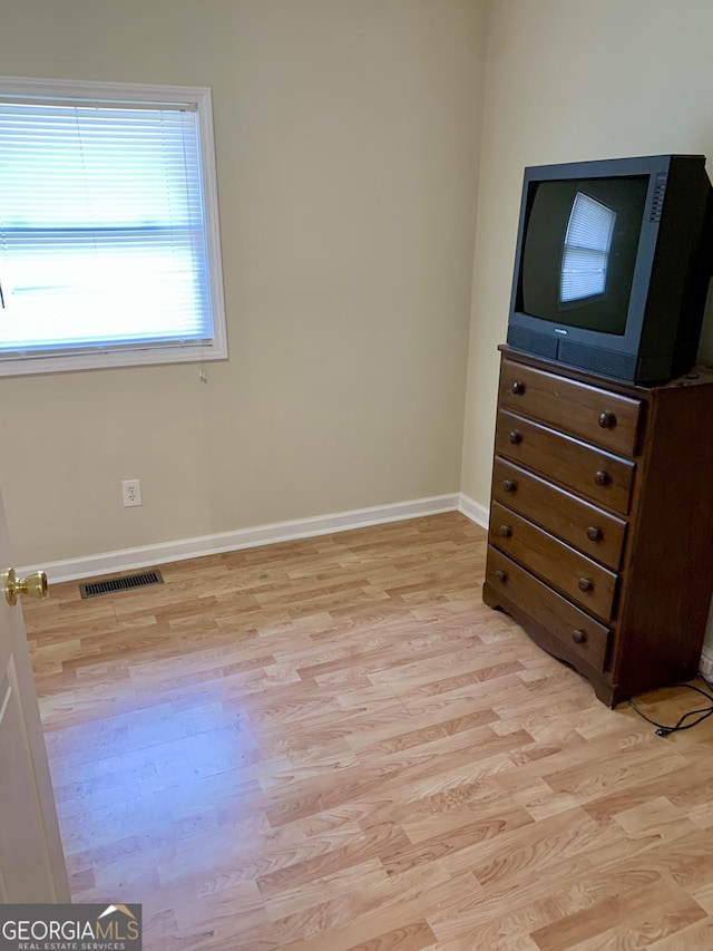 unfurnished bedroom with light wood-type flooring