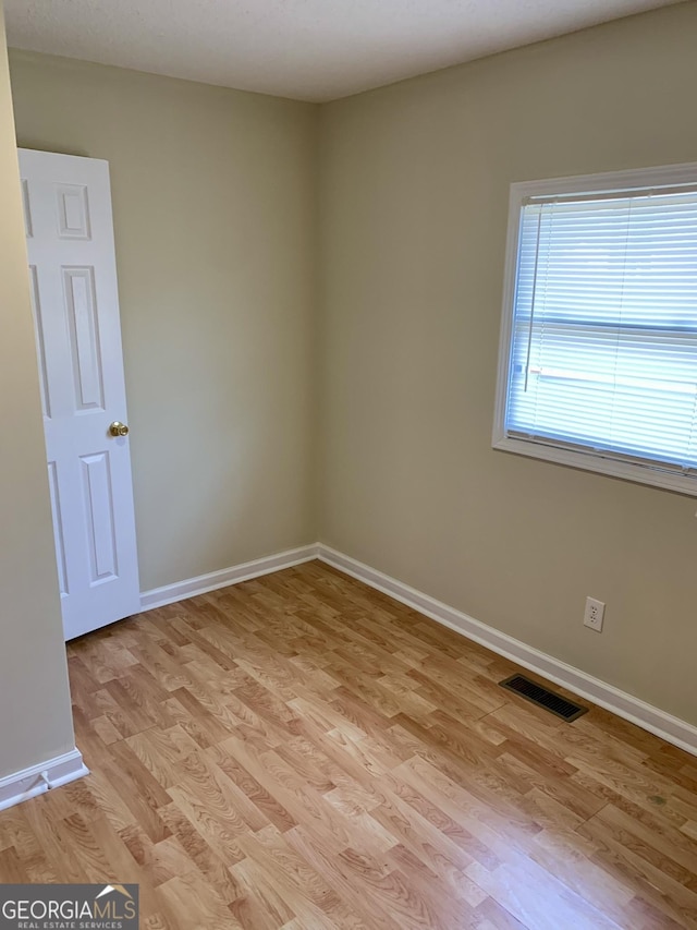 unfurnished room featuring light hardwood / wood-style flooring