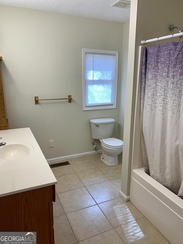 full bathroom featuring vanity, tile patterned flooring, a textured ceiling, and shower / bathtub combination with curtain